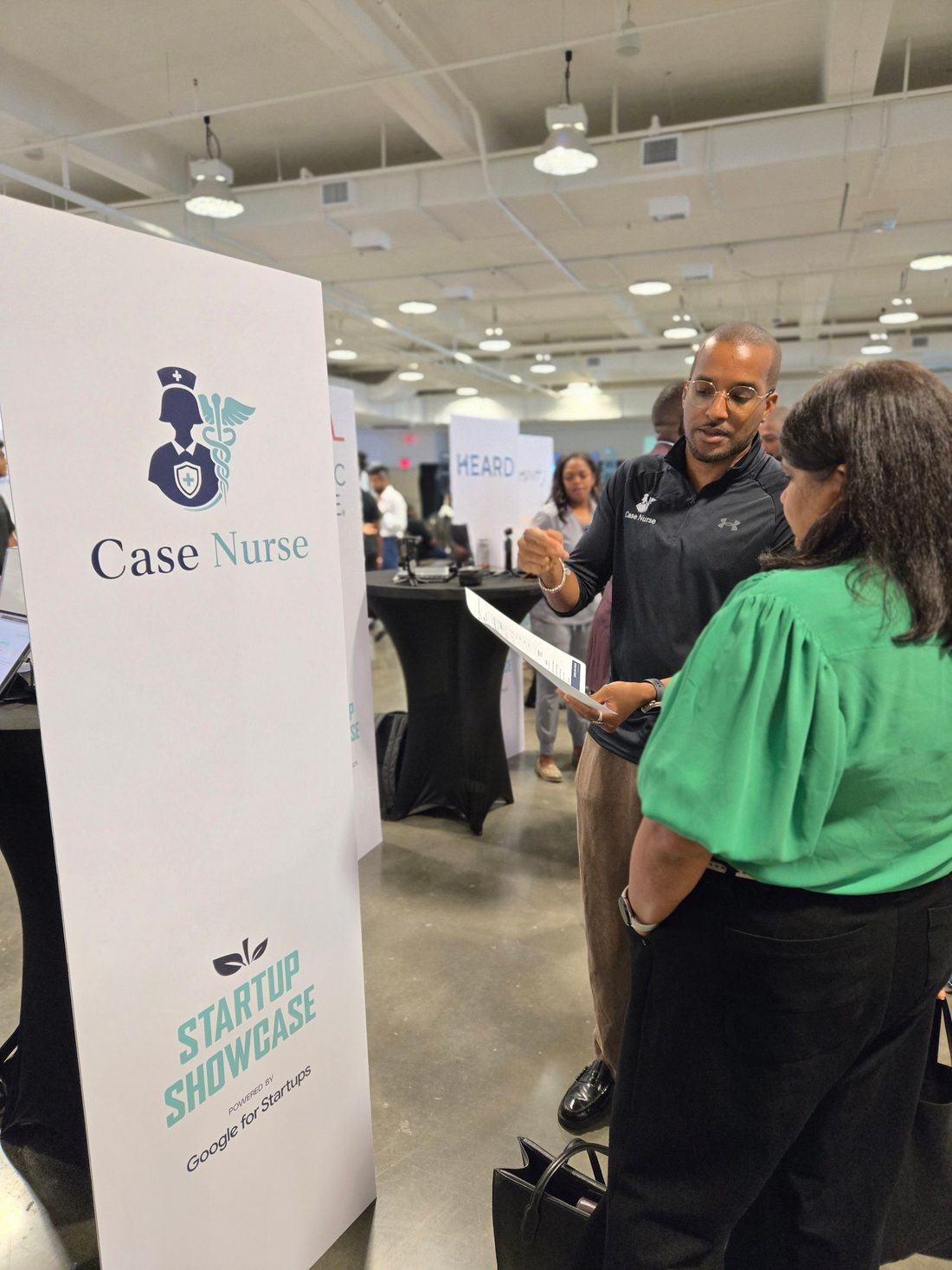 Talking with a visitor at the Case Nurse booth